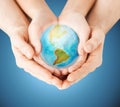 Close up of woman and man hands with earth globe Royalty Free Stock Photo