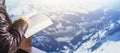 Close Up of a woman man Hold and reading a Holy Bible on Wood terres over snow mountain background.