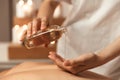 Close up of a woman masseur pouring massage oil Royalty Free Stock Photo