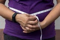 Close up of a woman measuring her waist with measuring tape Royalty Free Stock Photo