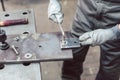 Close-up of woman metalworker in her workshop