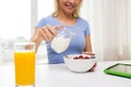 Close up of woman with milk jug eating breakfast Royalty Free Stock Photo