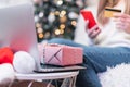 Close up of woman with mobile phone, credit card, present gift box and laptop. Online shopping at Christmas holidays Royalty Free Stock Photo