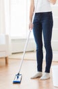 Close up of woman with mop cleaning floor at home Royalty Free Stock Photo