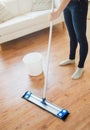 Close up of woman with mop cleaning floor at home Royalty Free Stock Photo