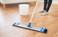 Close up of woman with mop cleaning floor at home Royalty Free Stock Photo