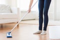 Close up of woman with mop cleaning floor at home Royalty Free Stock Photo