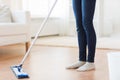 Close up of woman with mop cleaning floor at home Royalty Free Stock Photo