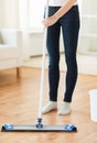 Close up of woman with mop cleaning floor at home Royalty Free Stock Photo