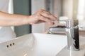 Close up Woman open chrome faucet washbasin to washing hands rubbing with soap for corona virus at water tap. Faucet and water Royalty Free Stock Photo