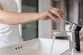 Close up Woman open chrome faucet washbasin to washing hands rubbing with soap for corona virus at water tap. Faucet and water Royalty Free Stock Photo