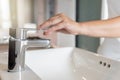 Close up Woman open chrome faucet washbasin to washing hands rubbing with soap for corona virus at water tap. Faucet and water Royalty Free Stock Photo