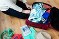 Close up of woman packing travel bag for vacation Royalty Free Stock Photo