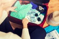 Close up of woman packing travel bag for vacation Royalty Free Stock Photo