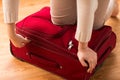 Close up of woman packing travel bag for vacation Royalty Free Stock Photo