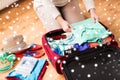 Close up of woman packing travel bag for vacation Royalty Free Stock Photo