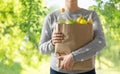 Close up of woman with paper bag full of food