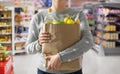 Close up of woman with paper bag full of food