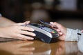 Close up woman paying by contactless card, terminal on bar counter Royalty Free Stock Photo