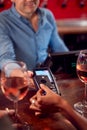 Close Up Of Woman Paying For Drinks At Bar After Work Using Contactless Card Royalty Free Stock Photo