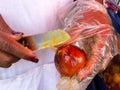 Close up of a woman peeling a chontaduro at Cali city center