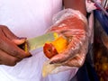 Close up of a woman peeling a chontaduro at Cali city center