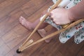 Close-up, a woman picks up a crutch, leans on it and walks. Rehabilitation after removal of plaster bandage. Royalty Free Stock Photo