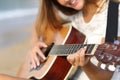 Close up of a woman playing guitar on the beach Royalty Free Stock Photo