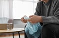 close up of woman popping bubble wrap at home