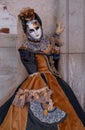 Woman poses in ornate, detailed costume, mask and hat, at the Doges Palace, St Mark`s Square during during Venice Carnival, Italy Royalty Free Stock Photo