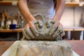 Close up of woman potter hands works with clay and ceramic, craftsman hands. knead and moistens the clay before work in ceramic Royalty Free Stock Photo