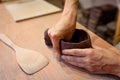 Close up of woman potter hands works with clay and ceramic, craftsman hands. knead and moistens the clay before work in ceramic Royalty Free Stock Photo