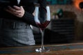 Close up of woman pouring red wine into glass. Dark warm colors Royalty Free Stock Photo