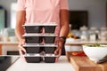 Close Up Of Woman Preparing Batch Of Healthy Meals At Home In Kitchen