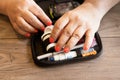 Close up of a woman preparing a glucometer device to test the glucose level