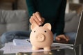 Close up woman putting coin into piggy bank, investment concept Royalty Free Stock Photo