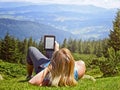 Close-up of woman reading e-book in nature Royalty Free Stock Photo