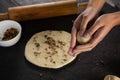 Woman rolling a dough ball in her hand