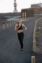 Close up of a woman running on a a road