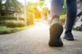 Close up woman running shoes, jogging on the road in a park Royalty Free Stock Photo