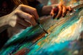 A close up of a woman's artist hands creating art painting in studio