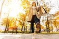 Close-up of a woman`s autumnal shoes, walking, a woman holding shopping bags on the street, in the park Royalty Free Stock Photo