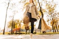 Close-up of a woman`s autumnal shoes, walking, a woman holding shopping bags on the street, in the park Royalty Free Stock Photo