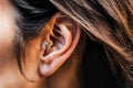 Close-up of woman\'s ear with unique earring placement