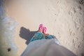 Close-up of a woman's foot in the shales on sand Royalty Free Stock Photo