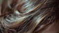 A close up of a woman& x27;s hair with some strands sticking out, AI