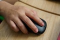 Close Up A woman`s hand is holding on a black mouse to operate the computer Royalty Free Stock Photo