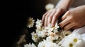 Close-up of a woman& x27;s hand holding a daisy, blurred greenery Royalty Free Stock Photo