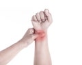 Close up woman's hand holding her wrist isolated on white . Elbo