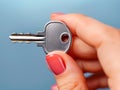 Close-up of a woman\'s hand holding a house key Royalty Free Stock Photo